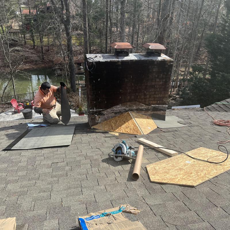 work being done on a shingle roof