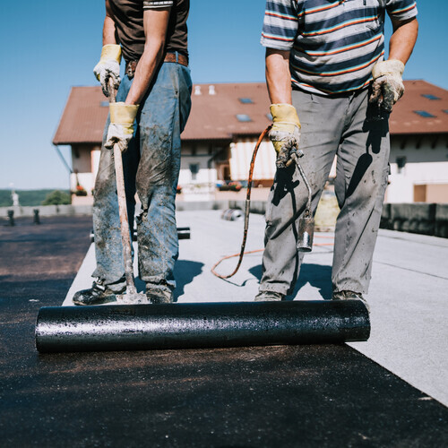 workers installing commercial roofing