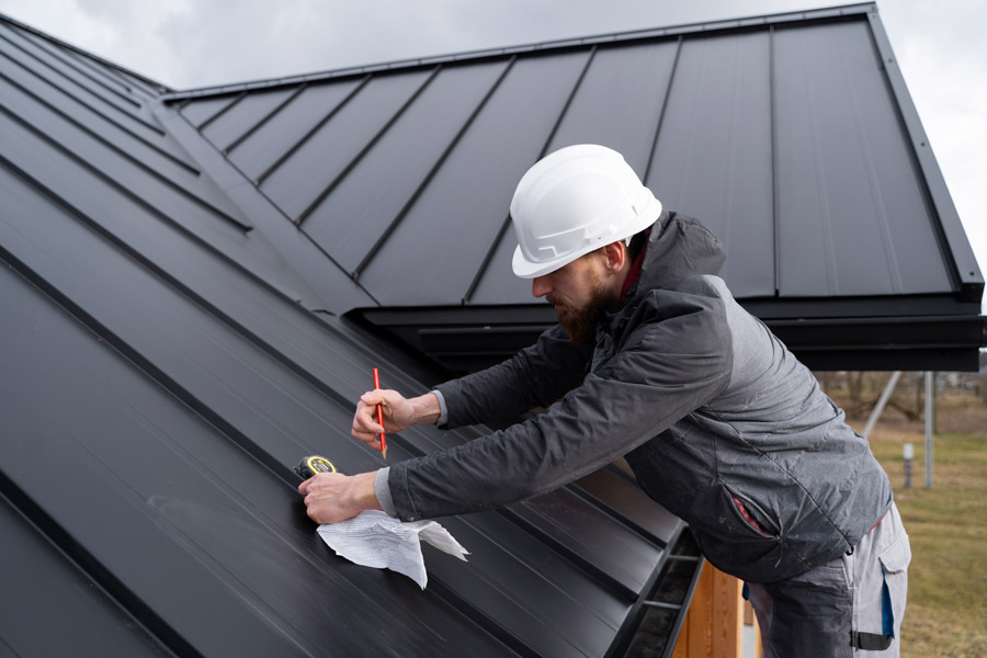 workers on a standing seam metal roof